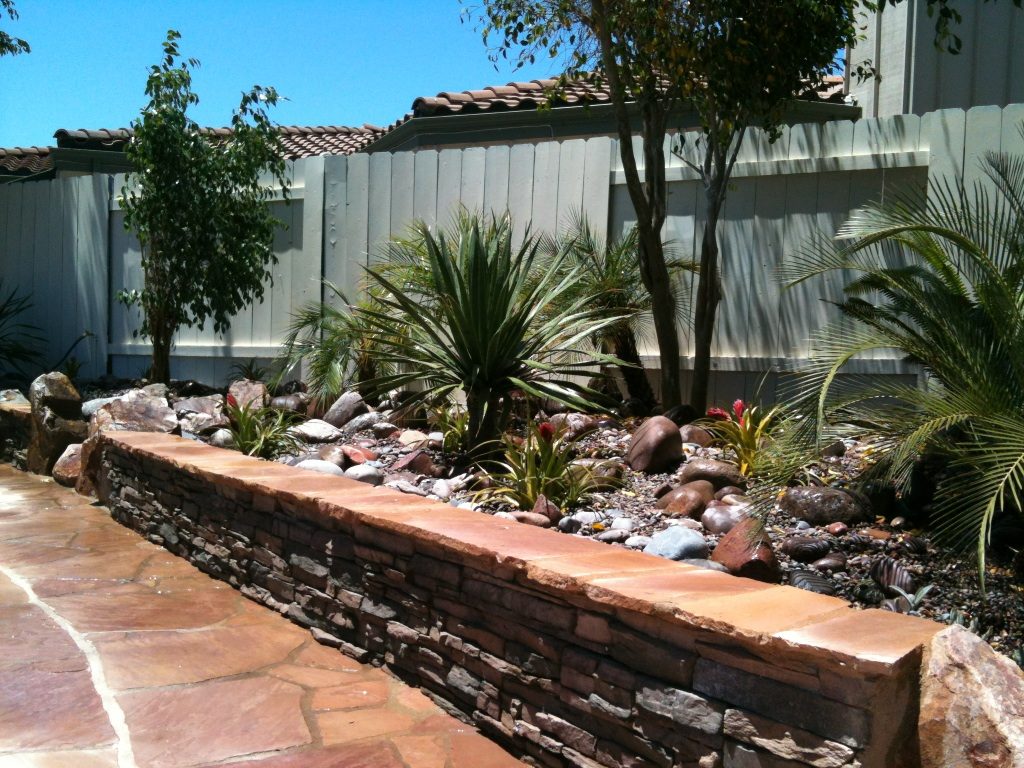 Lottes Residence &mdash; Raised stone planter wall with palms