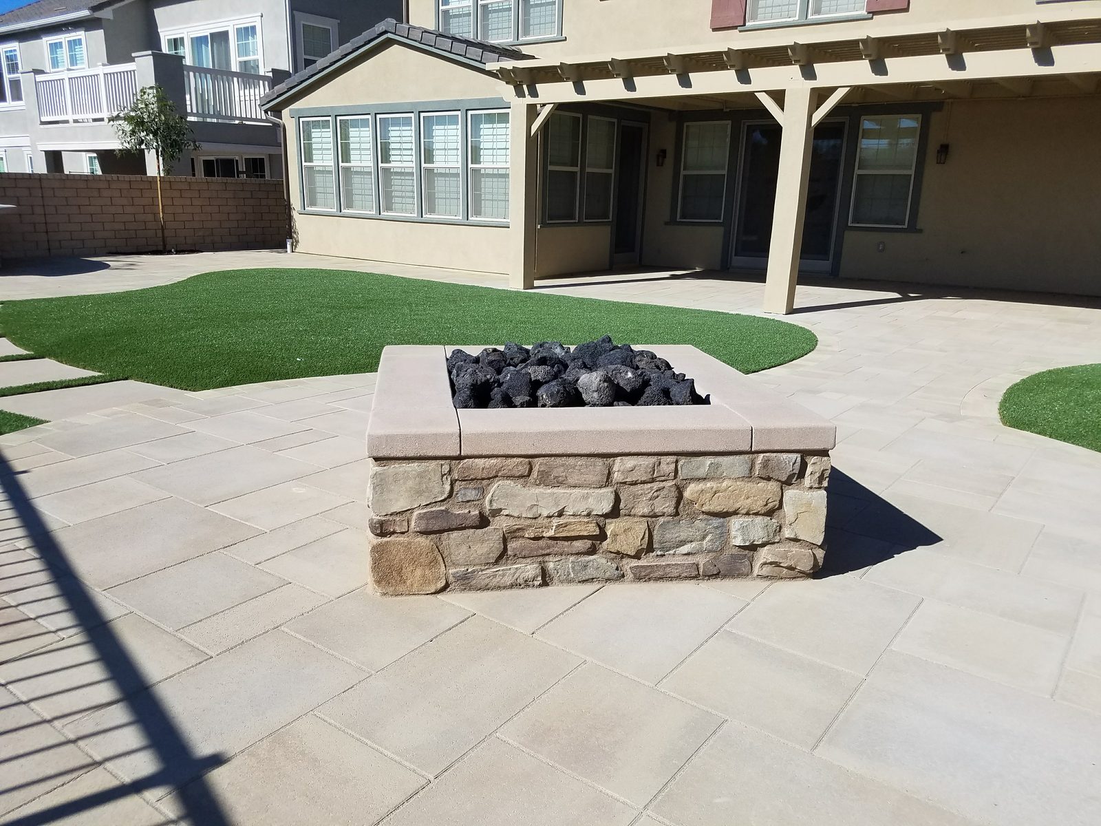 Matej Residence &mdash; Fire pit, pavers, and turf for everyday use