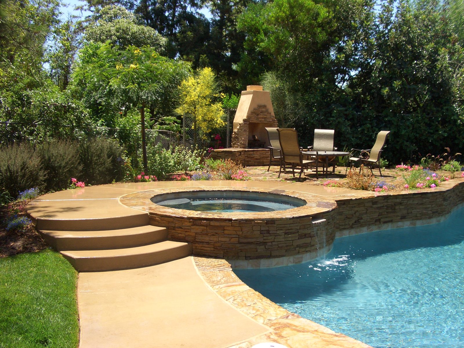 Peterson Residence &mdash; Freeform pool and spa with the stone fireplace beyond