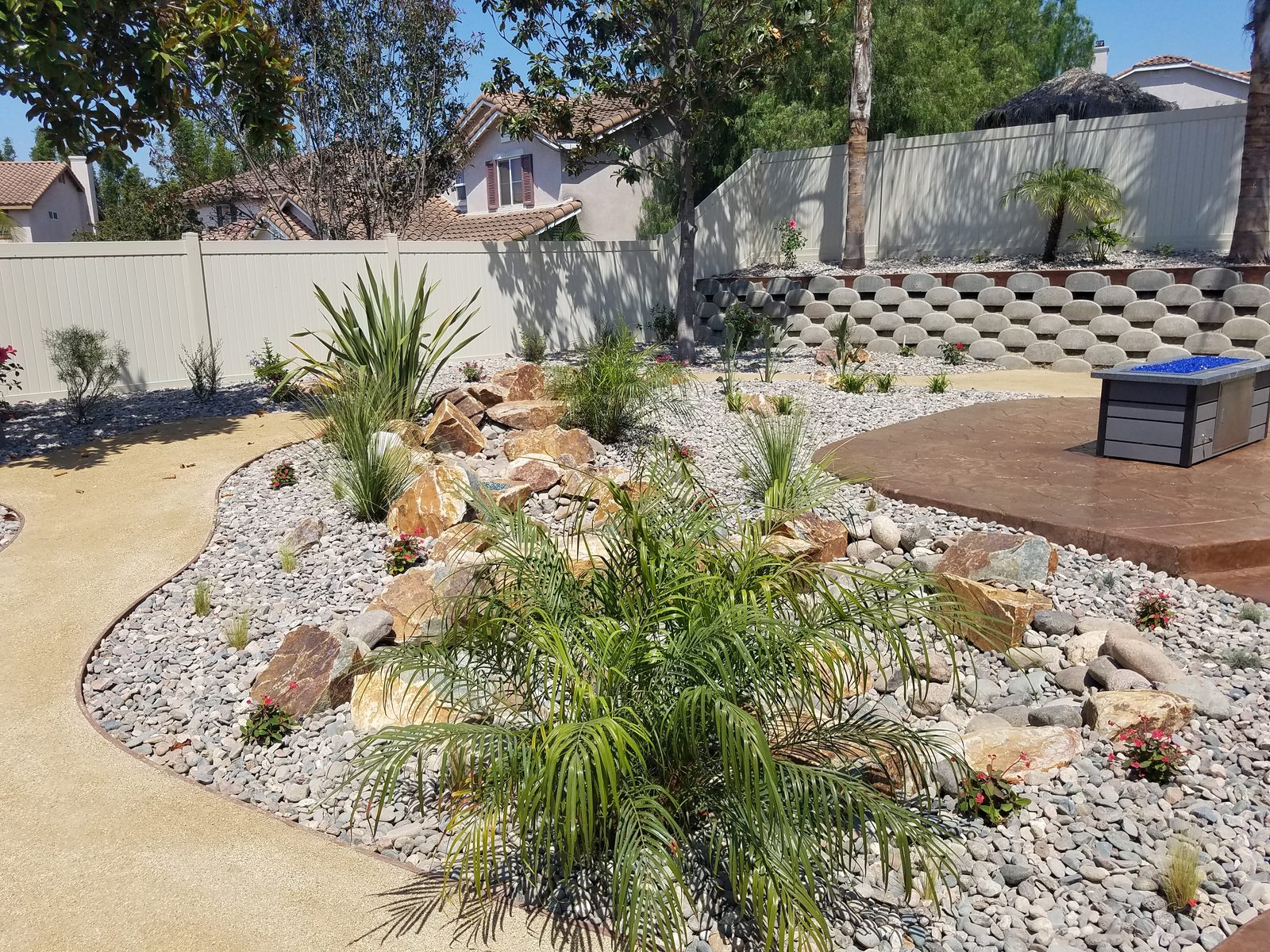 Quintero Residence &mdash; Checkerboard turf-and-paver design with boulders