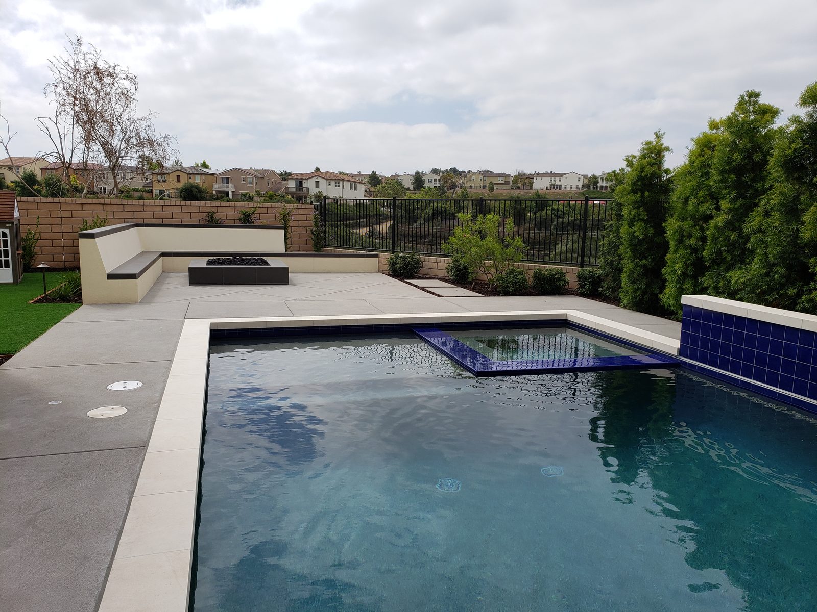 Custom pool and raised spa with stone coping and integrated decking on a San Diego property