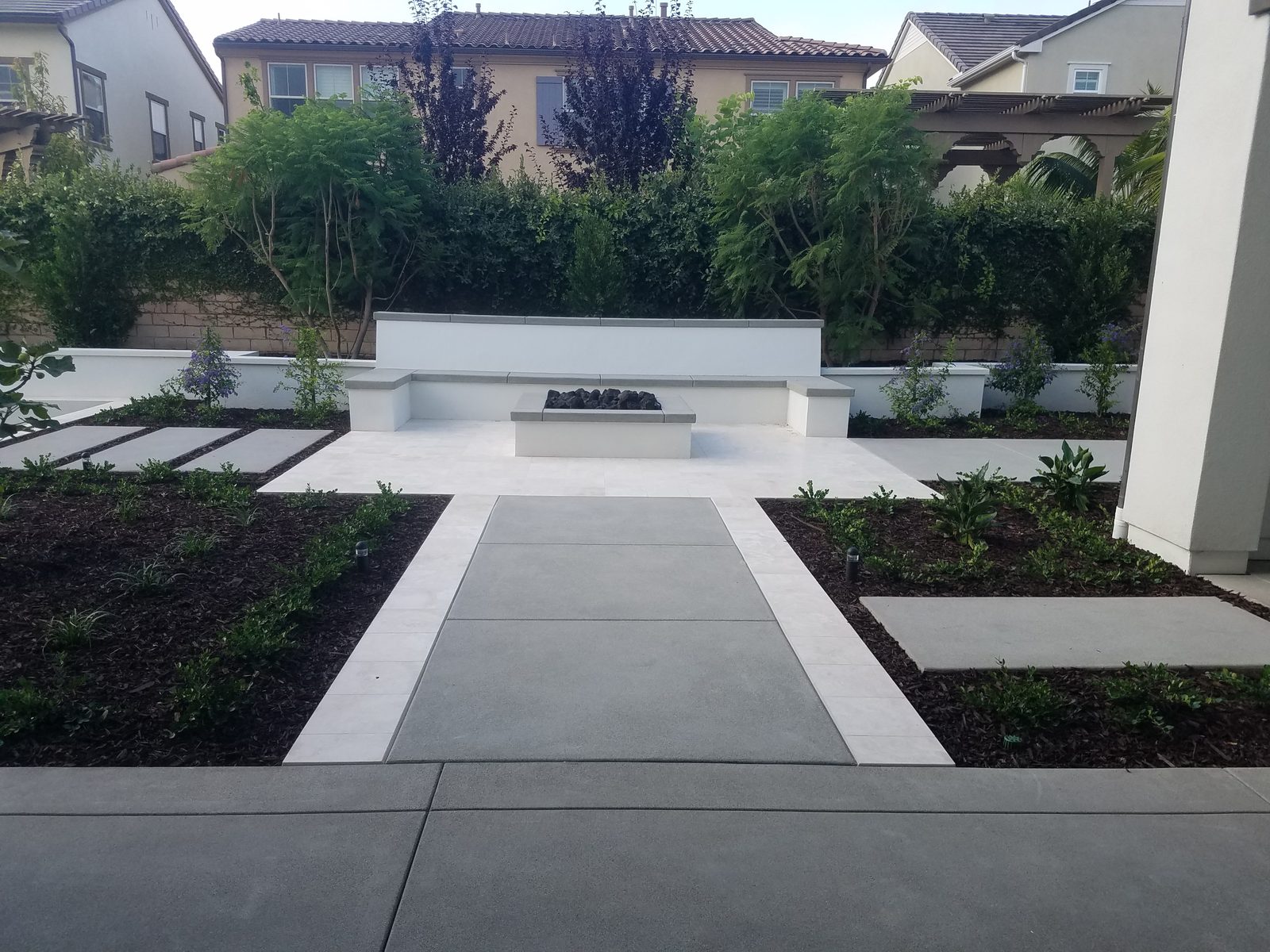 Xu Residence &mdash; Linear pavers and planters with a fire feature