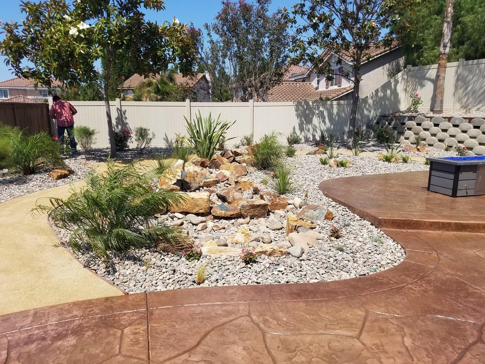 Dry-creek drainage swale directing runoff away from the house before the patio was installed