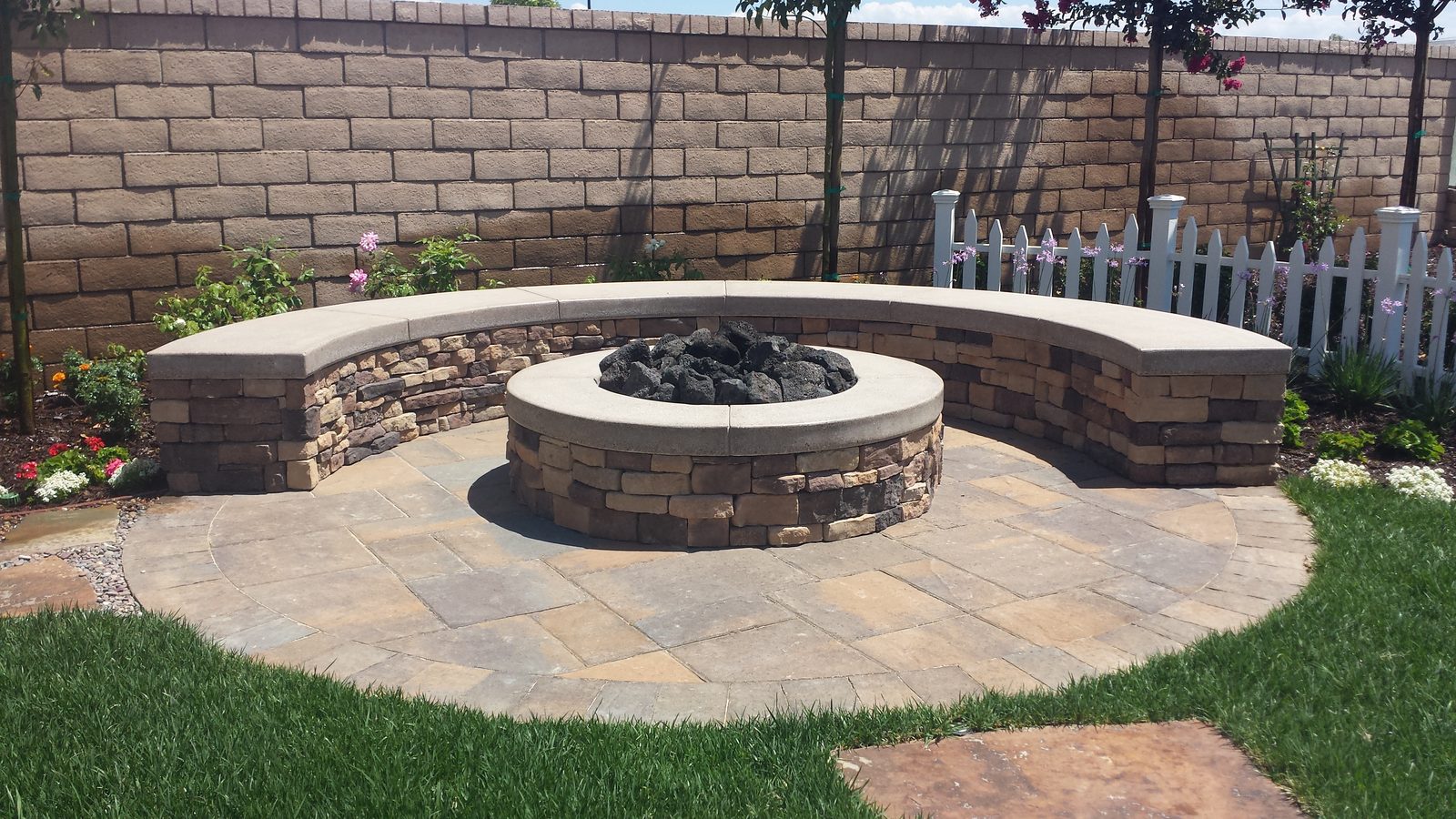 Stacked-stone gas fire pit with bench seating