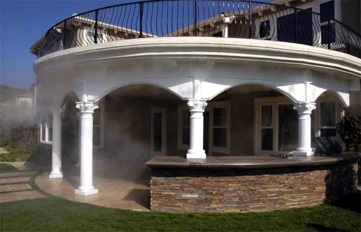 Covered outdoor kitchen and stacked-stone bar under a structural colonnade