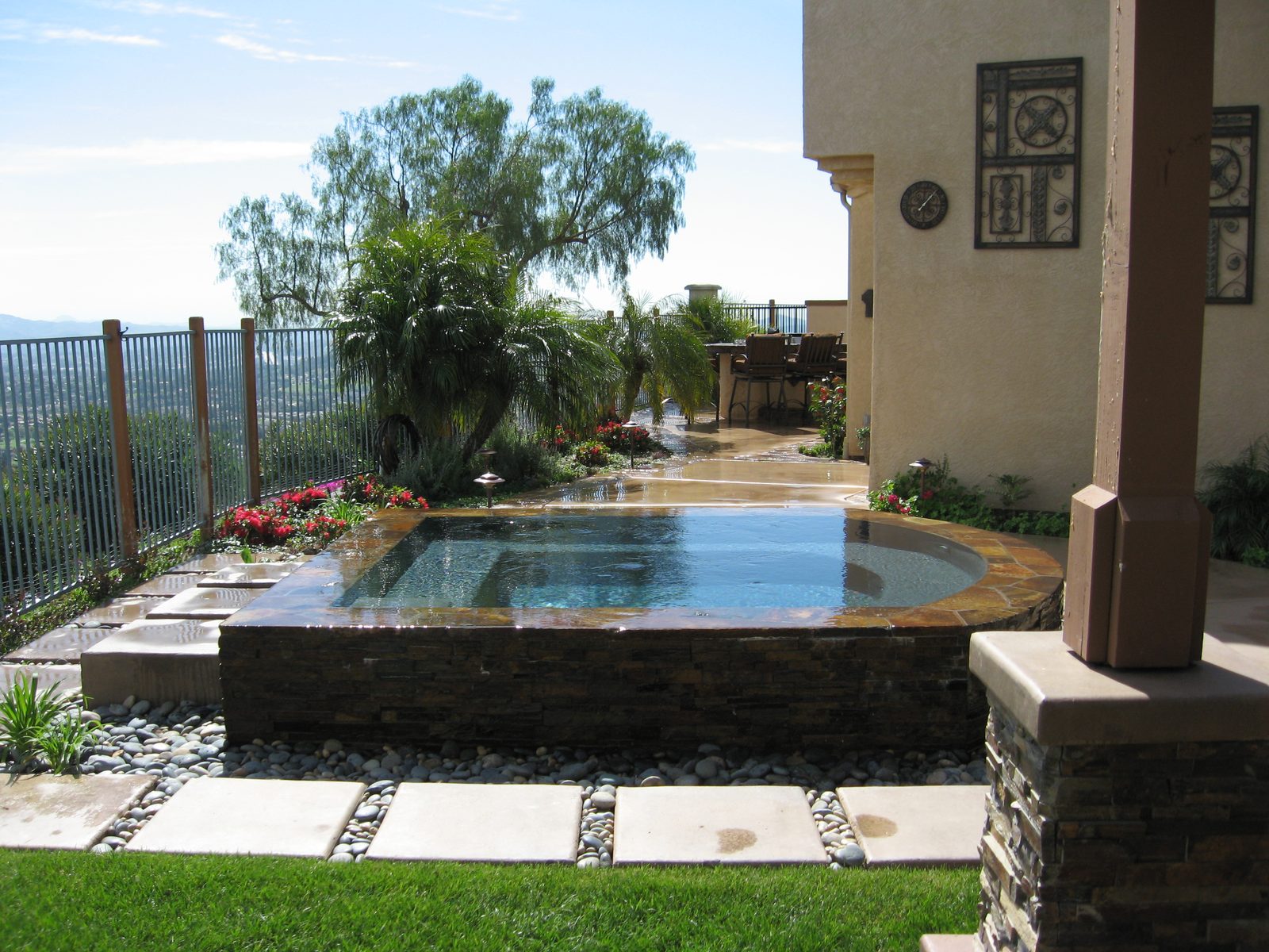 Infinity-edge spa built into a canyon-view lot in San Diego County